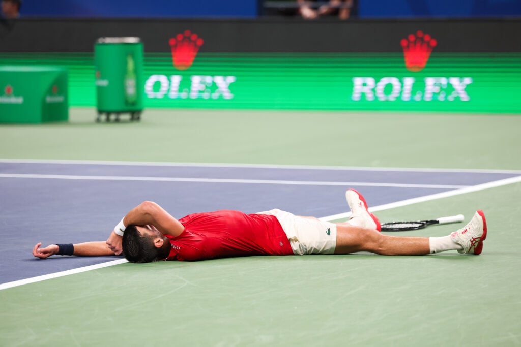 Novak Djokovic lies on the floor during his match with Jaume Munar at the 2025 Shanghai Masters