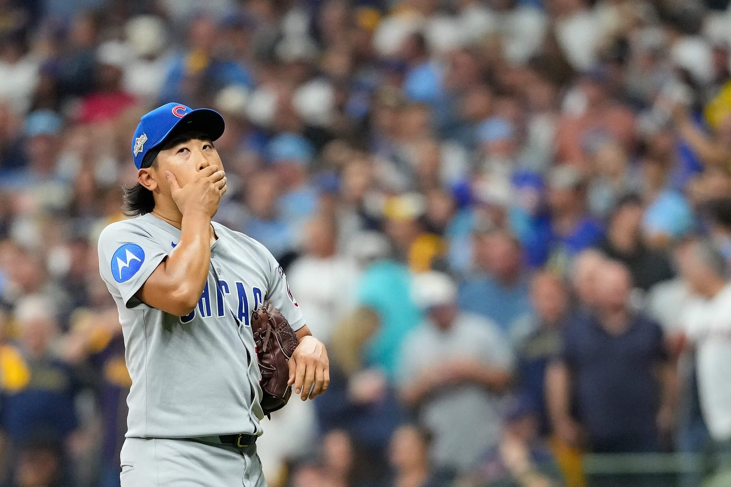 Cubs pitcher Shota Imanaga places his hand across his face during the NLDS
