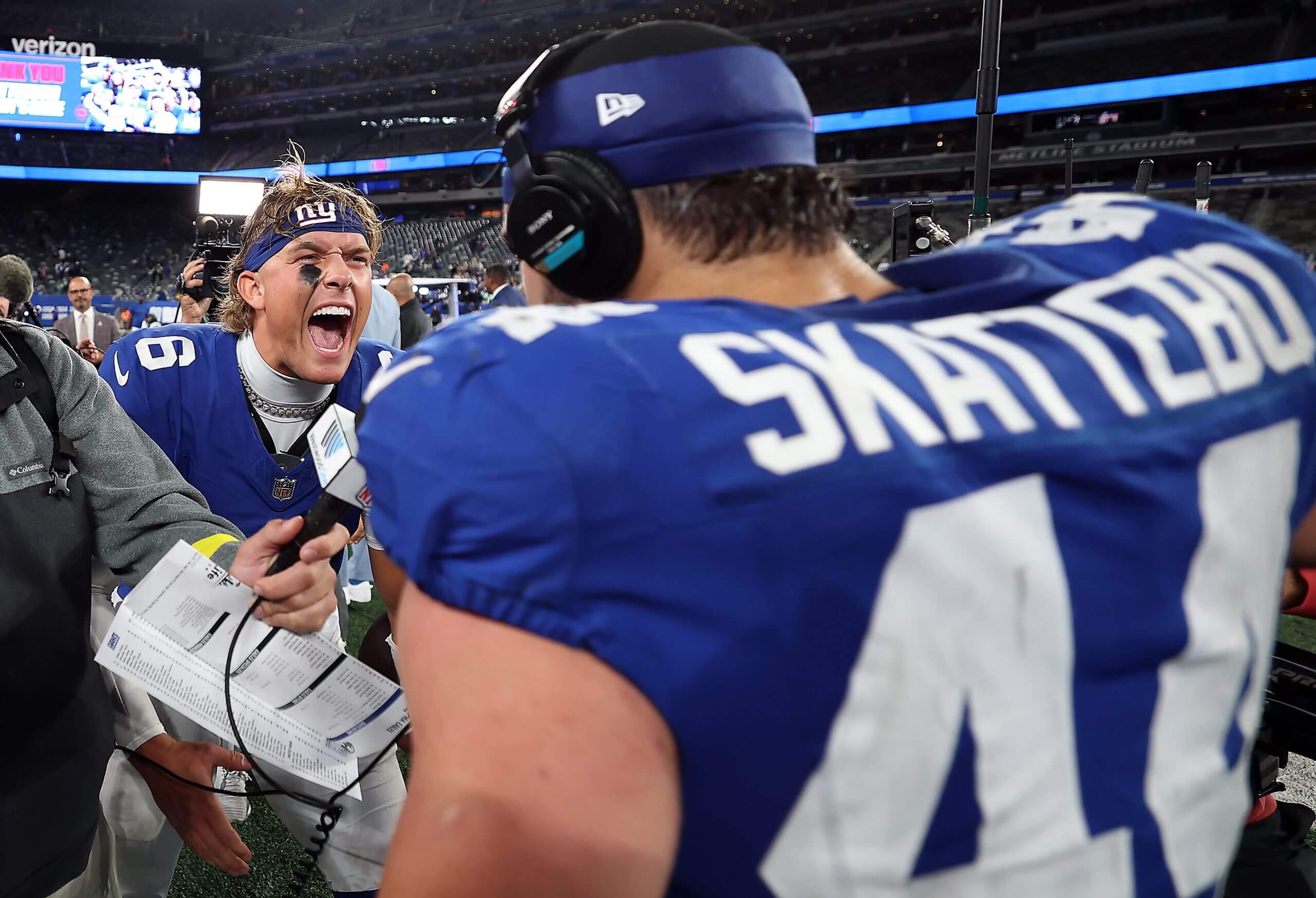 Giants teammates Jaxson Dart and Cam Skattebo celebrate after a win over the Eagles.