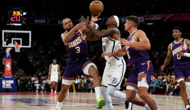 Terance Mann #14 of Brooklyn Nets competes with Dillon Brooks #3 of Phoenix Suns during NBA China G...