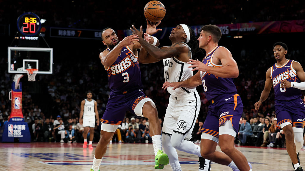 Terance Mann #14 of Brooklyn Nets competes with Dillon Brooks #3 of Phoenix Suns during NBA China G...