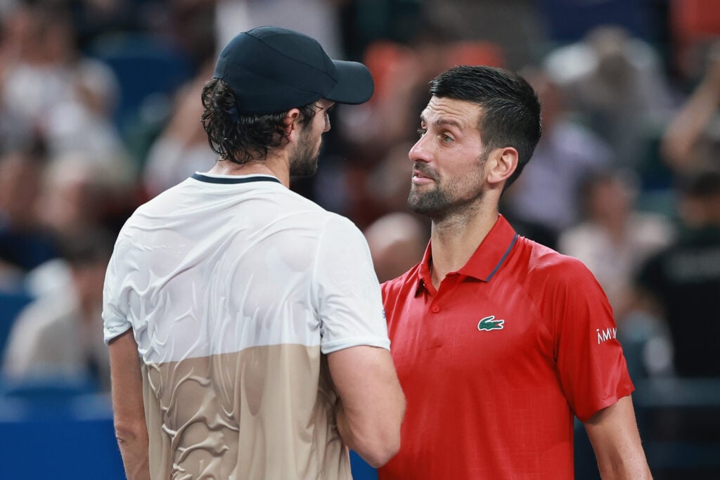 Novak Djokovic and Valentin Vacherot meet at the net after their semifinal match in Shanghai.