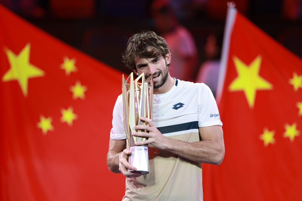 Valentin Vacherot biting the Shanghai Masters trophy.