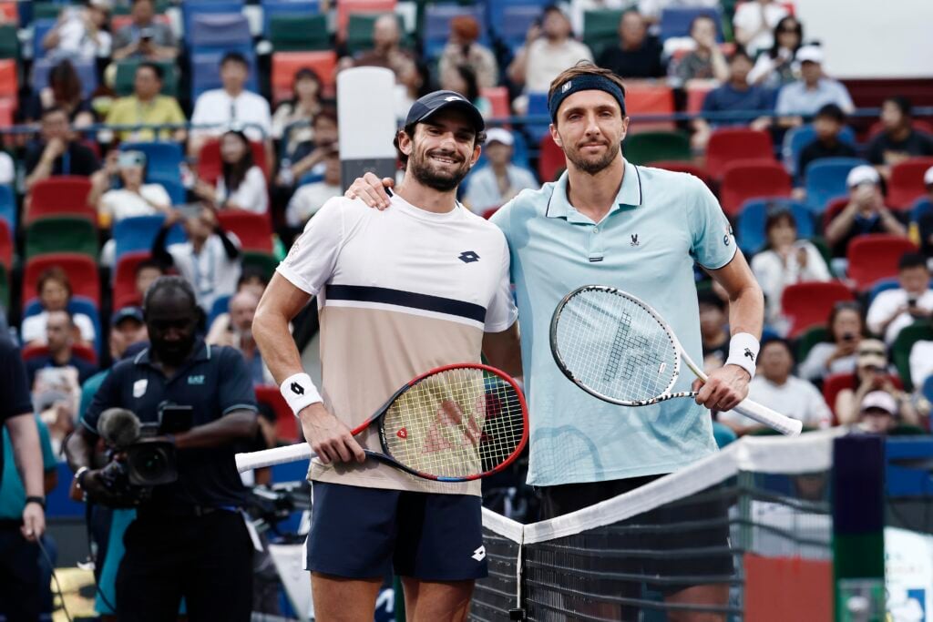 Valentin Vacherot and Arthur Rinderknech meet at the net before the 2025 Shanghai Masters final.