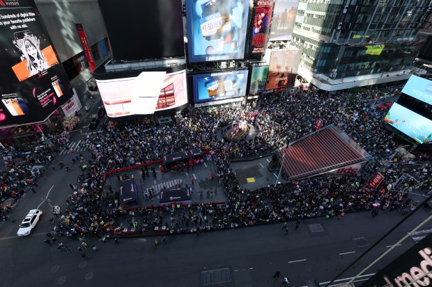 People gather at Times Square during a "No Kings" national day of protest in New York on October 18, 2025. From New York to San Francisco, millions of Americans are expected to hit the streets to voice their anger over President Donald Trump's policies at nationwide "No Kings" protests. (Photo by TIMOTHY A.CLARY / AFP) (Photo by TIMOTHY A.CLARY/AFP via Getty Images)