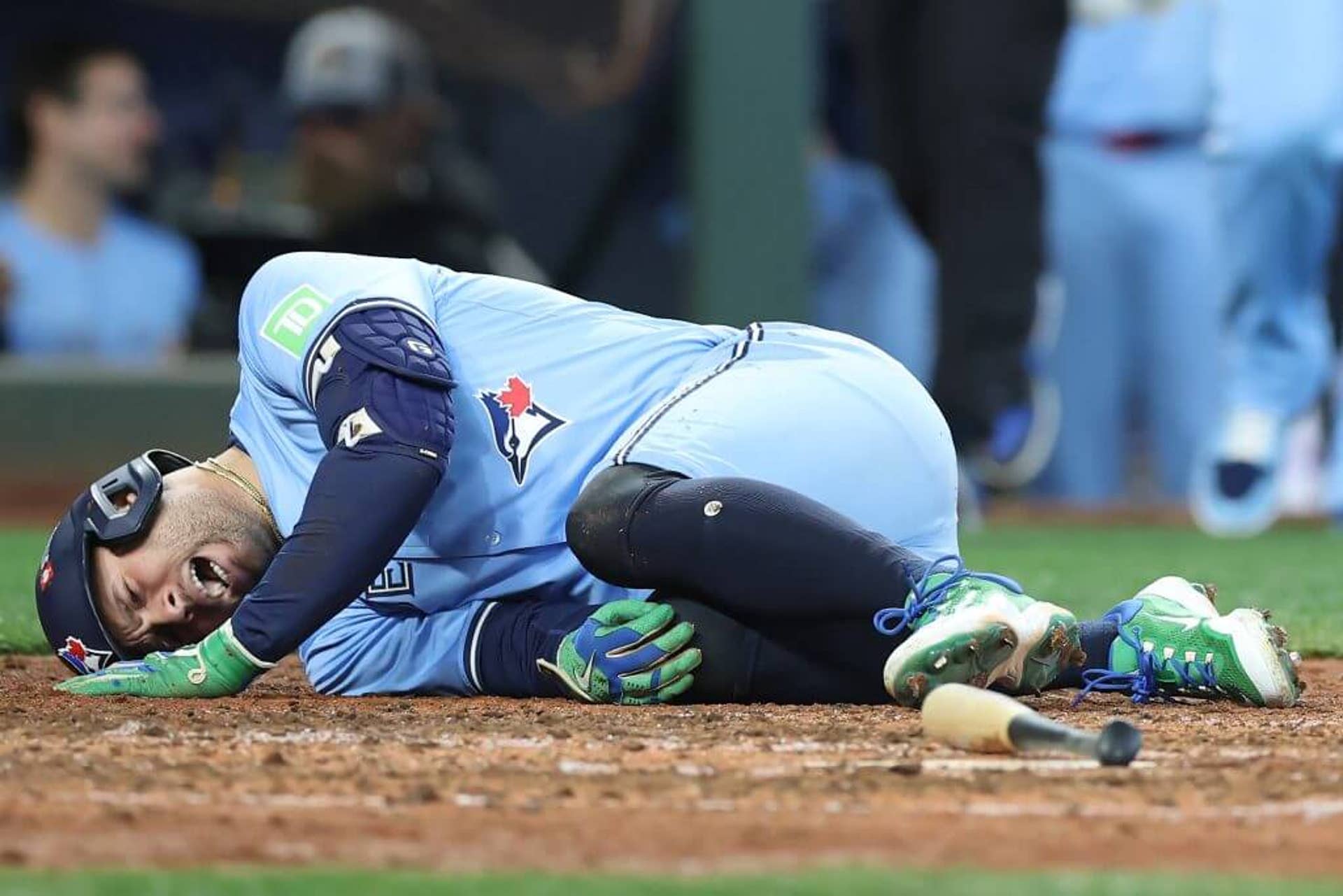 George Springer grabs his knee after getting hit by a pitch