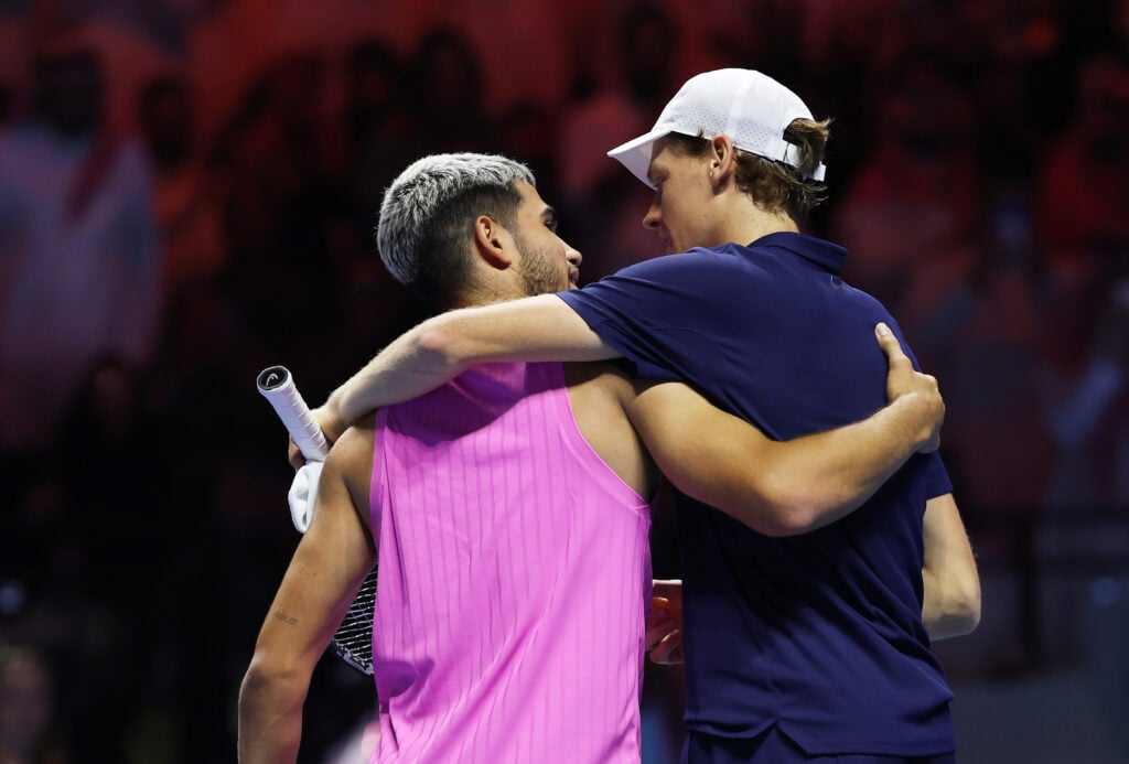 Carlos Alcaraz and Jannik Sinner embrace after the 2025 Six Kings Slam final