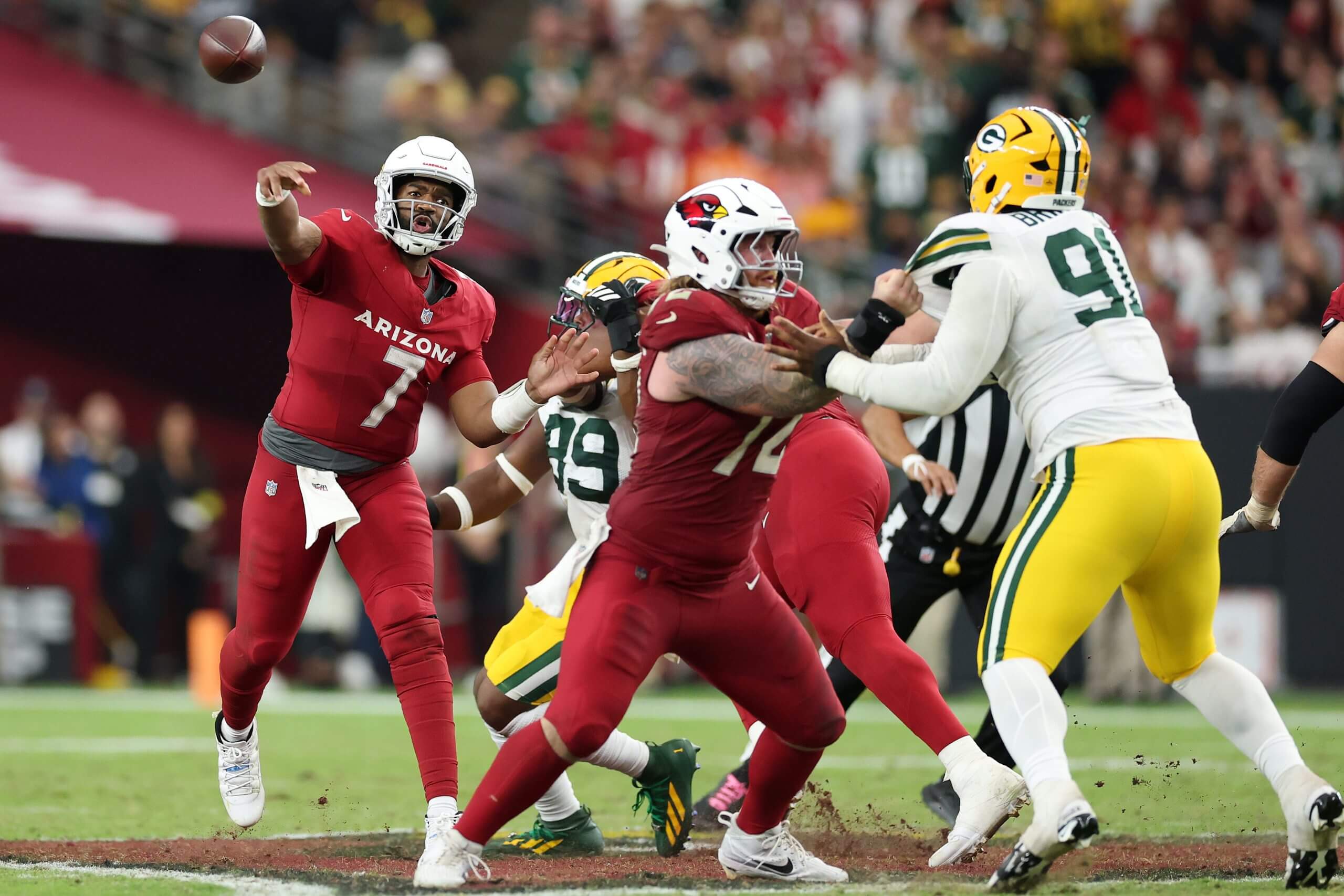 Cardinals quarterback Jacoby Brissett throws a pass behind his offensive line during Sunday's loss to the Packers.