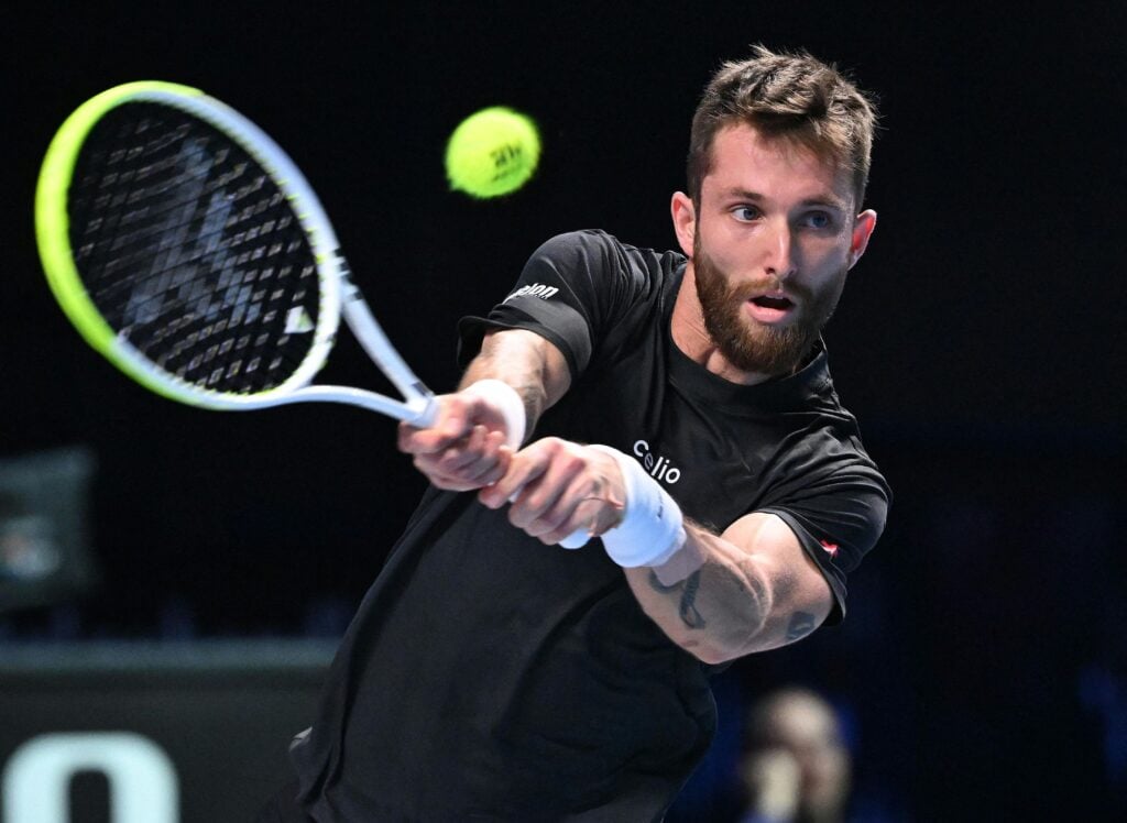 Corentin Moutet plays a backhand at the Vienna Open.
