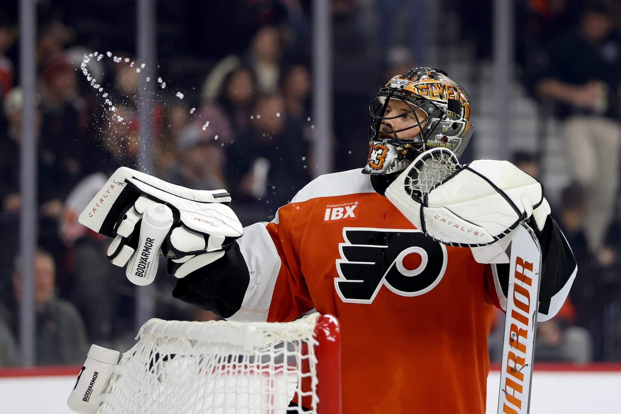 Samuel Ersson sprays his water bottle into the air during a break in play.