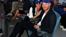 LOS ANGELES, CA - OCTOBER 28:  Prince Harry, Duke of Sussex and Meghan, Duchess of Sussex pose for a photo during Game Four of the 2025 World Series presented by Capital One between the Toronto Blue Jays and the Los Angeles Dodgers at Dodger Stadium on Tuesday, October 28, 2025 in Los Angeles, California. (Photo by Joe Scarnici/MLB Photos via Getty Images)