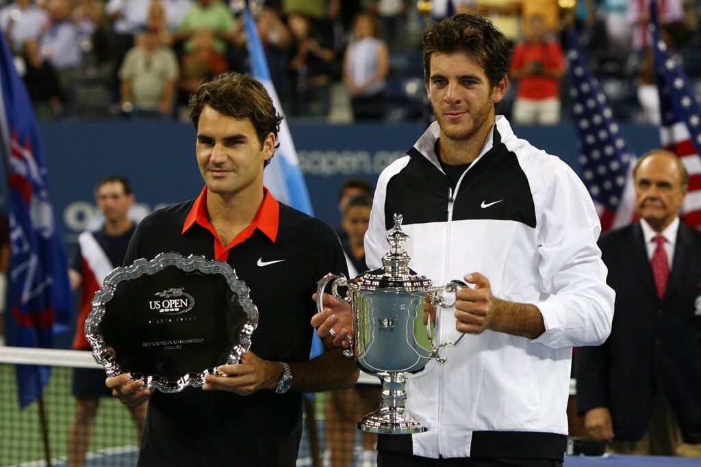Roger Federer and Juan Martin Del Potro hold their US Open trophies.