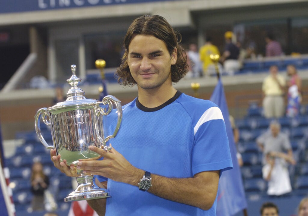 Roger Federer holding the men's singles title after winning the 2004 US Open.