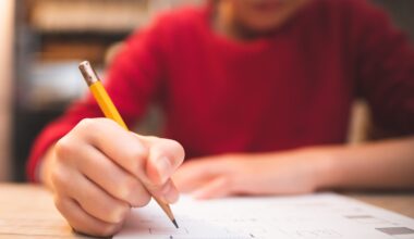 A child writes at his desk in class.