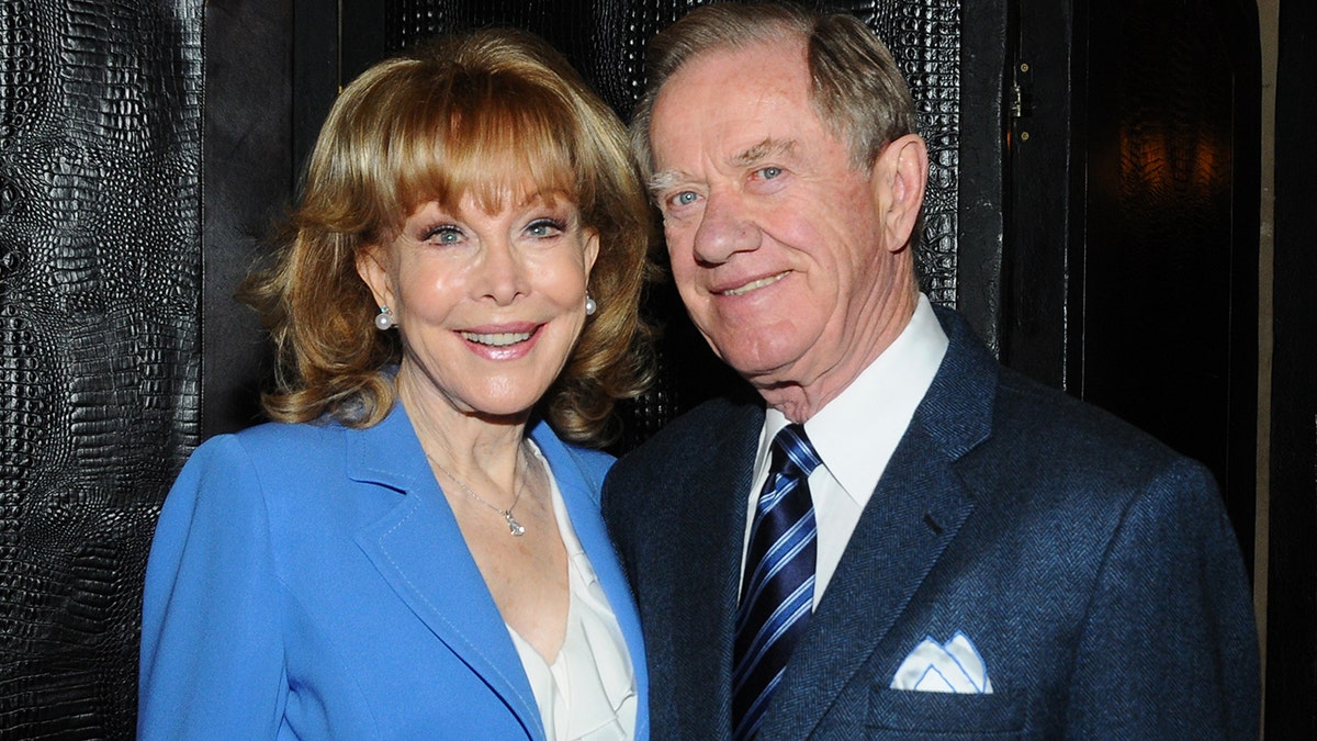 Barbara Eden smiling alongside her husband while enjoying a date out.