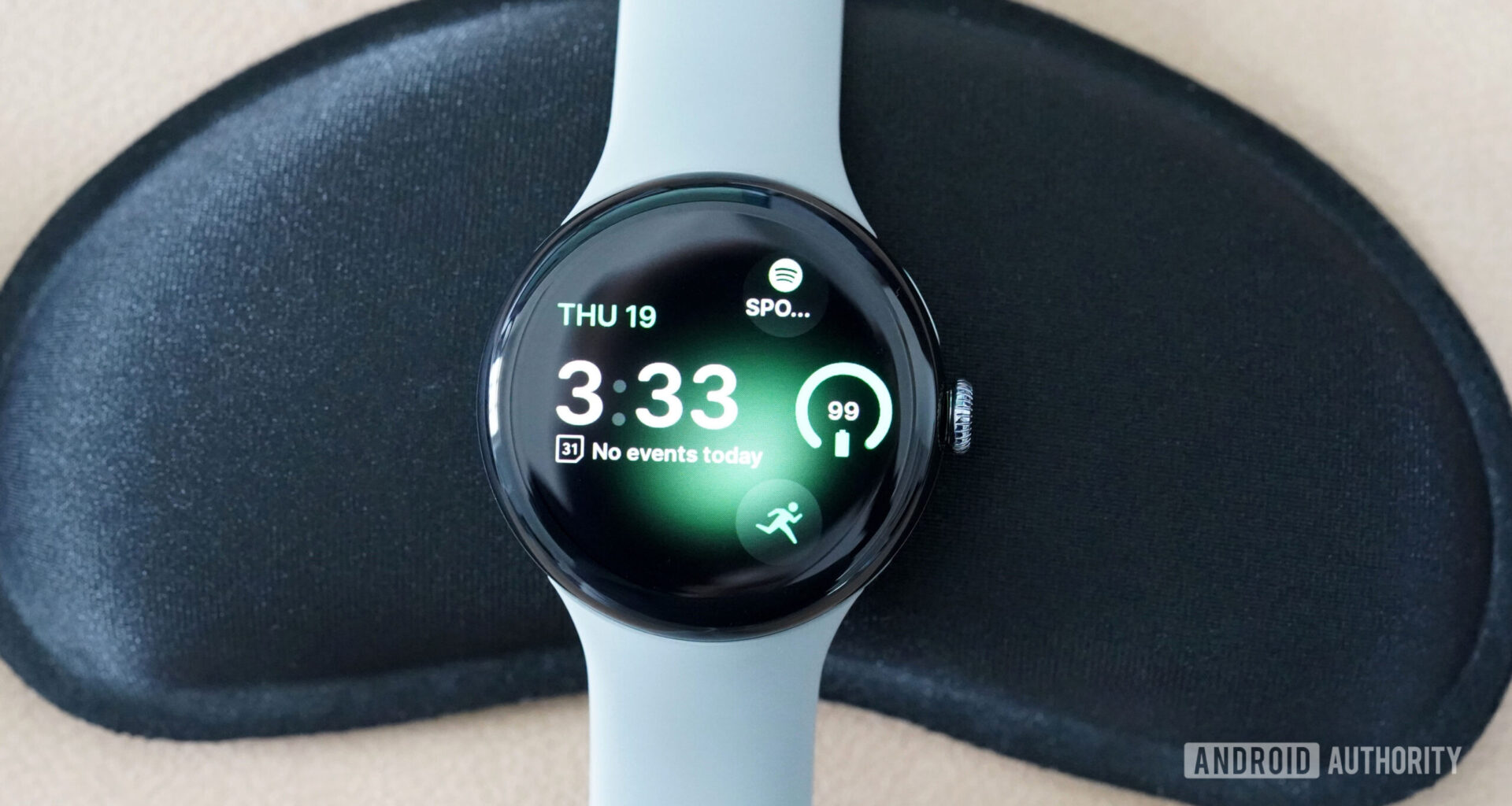 A Google Pixel Watch 3 displays the watch face Tidal Glow.