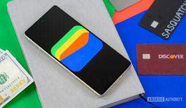 Google Wallet logo on smartphone next to credit cards and cash Stock photo 9