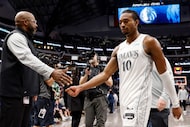 Dallas Mavericks guard Brandon Williams (10) high-fives a member of the Mavericks staff...