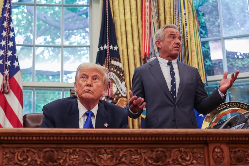 US Secretary of Health and Human Services Robert F. Kennedy Jr. (R) speaks US President Donald Trump during an executive orders signing event in the Oval Office of the White House in Washington, DC, on May 5, 2025. Trump signed several health care-related executive orders, according to a White House statement. (Photo by Alex Wroblewski / AFP) / ALTERNATE CROP (Photo by ALEX WROBLEWSKI/AFP via Getty Images)