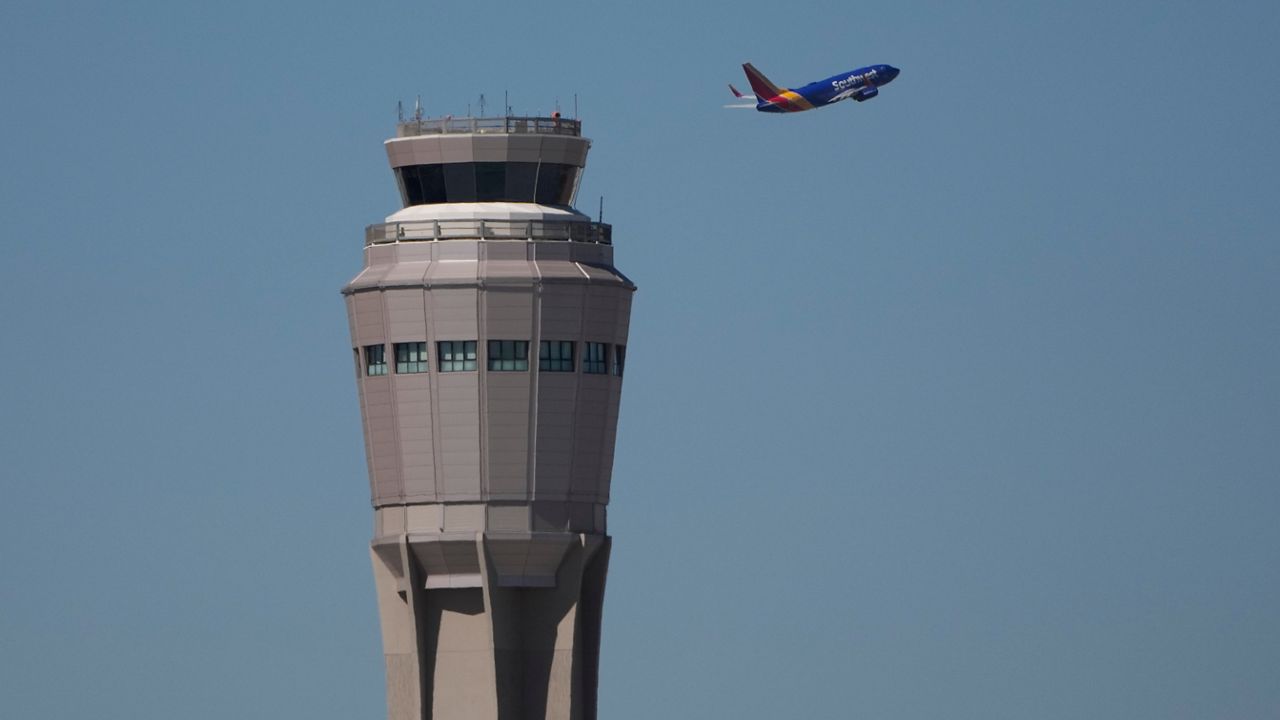 Planes land and take off at Harry Reid International Airport, Tuesday, Oct. 7, 2025, in Las Vegas. (AP Photo/John Locher)