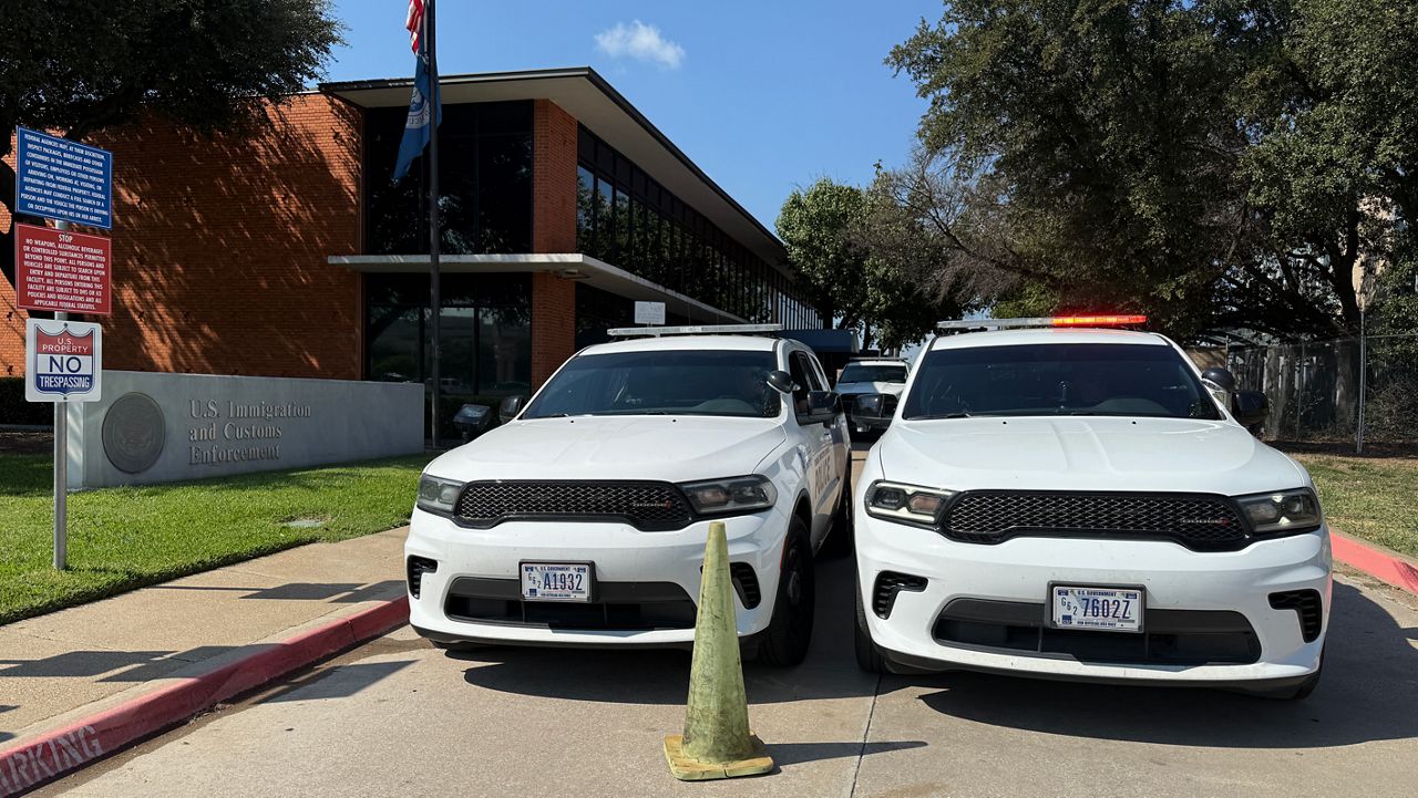 Police vehicles outside of an ICE facility in Dallas. (Spectrum News 1/Lauren Rangel)