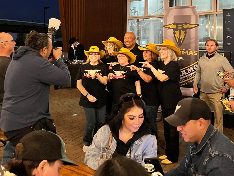 The Brahma Mammas (center), a woman-run fan group, and other fans attend a party last week for the coming debut of the San Antonio Brahmas, the city's new XFL professional football team.