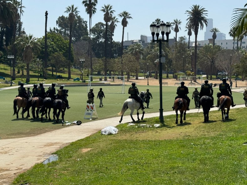 Federal agents on horseback in MacArthur Park during immigration enforcement excercise.