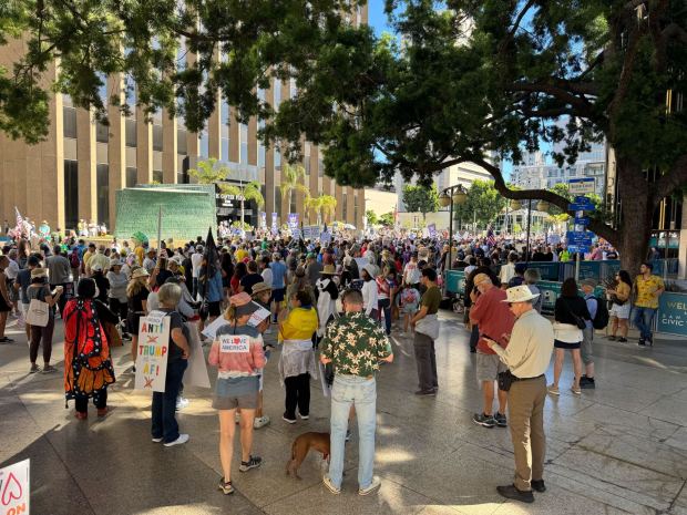 Hundreds gather downtown before the start of "No Kings" protests at San Diego Civic Plaza. (San Diego Union-Tribune/Phillip Molnar)