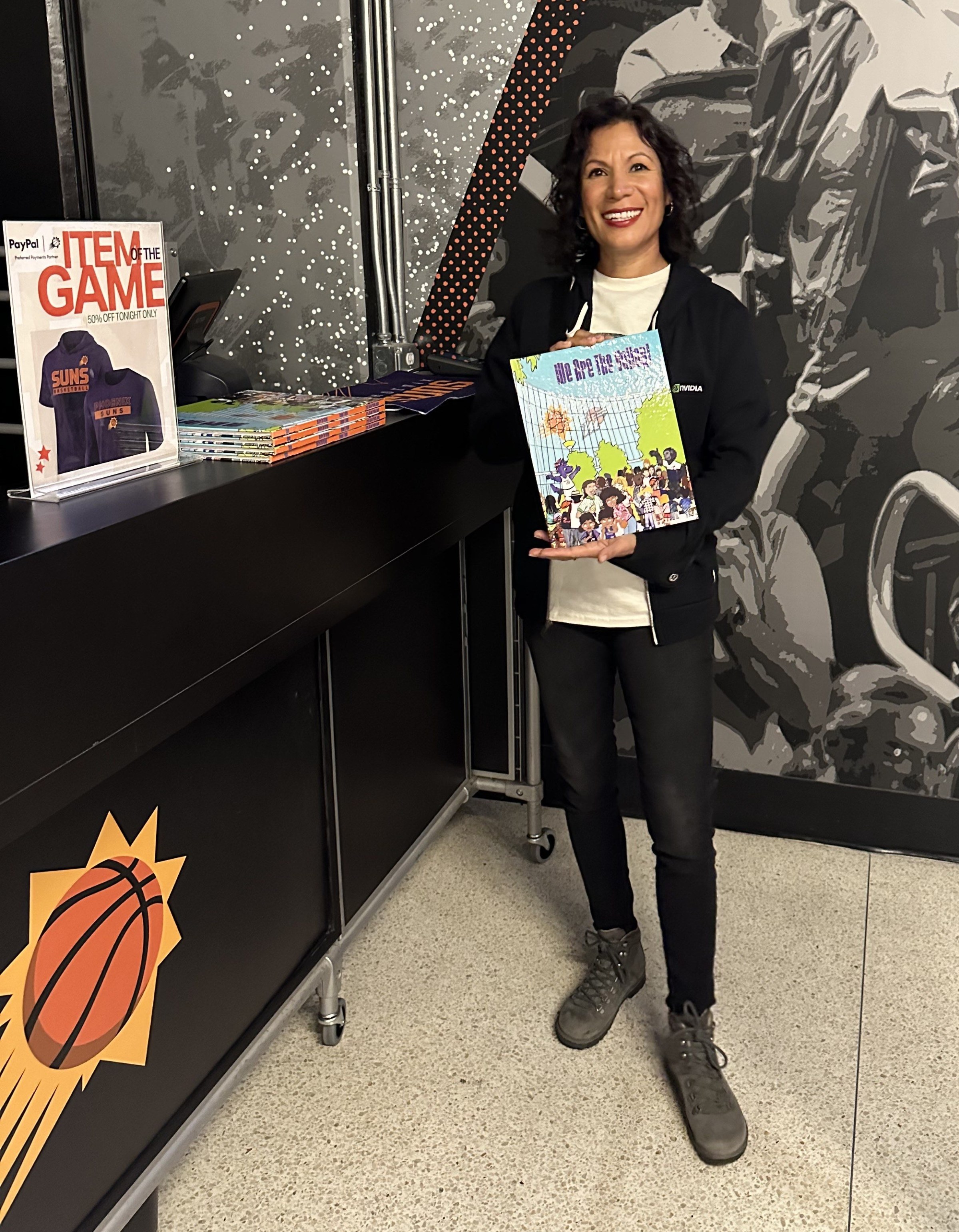 Author Claudia Sloan holding a copy of her children’s book.