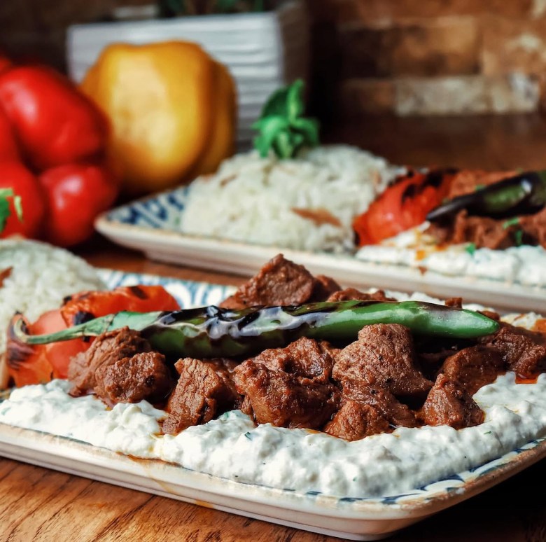 a Turkish meat and rice plate with a pepper on top