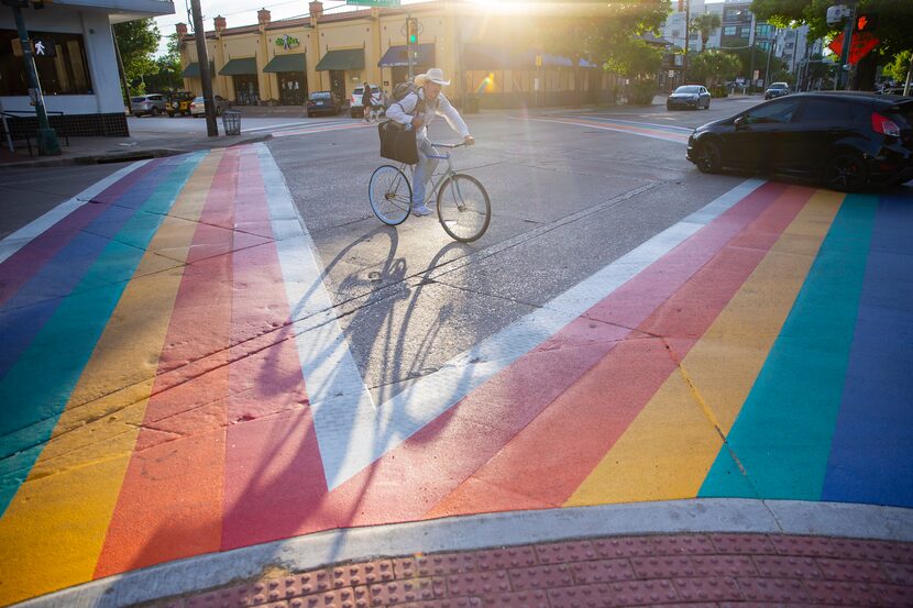 A cyclist bikes past the rainbow crosswalks on Cedar Springs and Throckmorton St. in Oak...