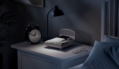 A smartphone tucked into the IKEA Phone Sleep Collection bed.