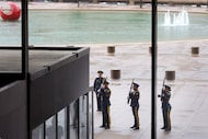 The Dallas Honor Guard fires a 21-gun salute on the Dallas City Hall Plaza just outside the...