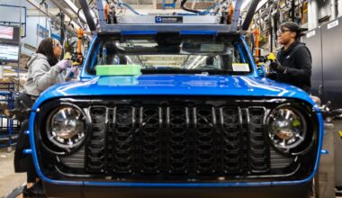 Production operators at the Toledo Assembly Complex secure the windshield of the 2024 Jeep Gladiator into position.