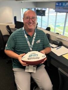 Jeff Asch holds the game ball given to him by the Philadelphia Eagles.