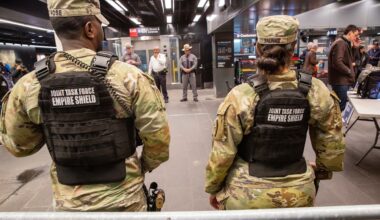Members of the Armed Forces, including the National Guard, patrol the subway system in Penn Station as police officers check commuters' bags in New York on Thursday, March 7, 2024. (AP Photo/Ted Shaffrey, File)