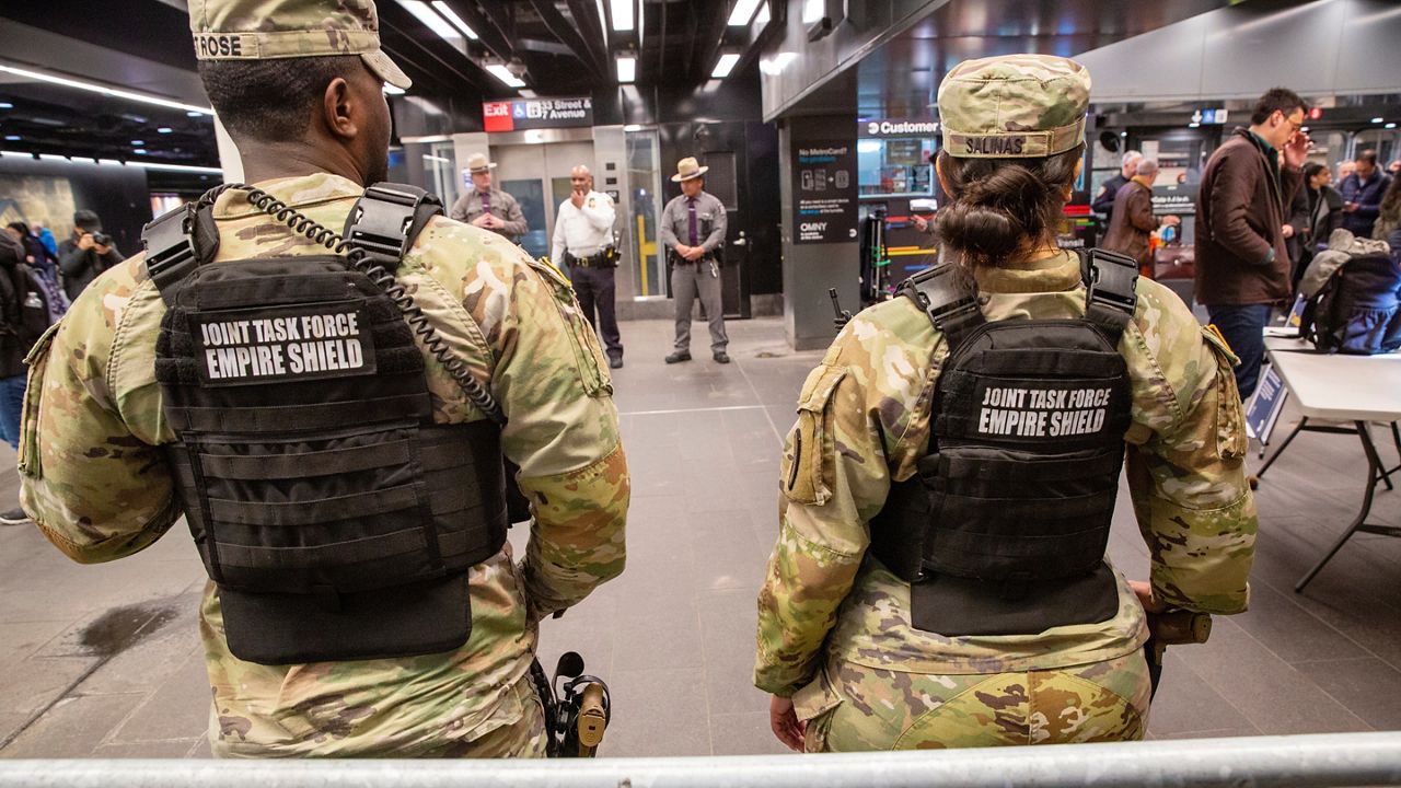 Members of the Armed Forces, including the National Guard, patrol the subway system in Penn Station as police officers check commuters' bags in New York on Thursday, March 7, 2024. (AP Photo/Ted Shaffrey, File)
