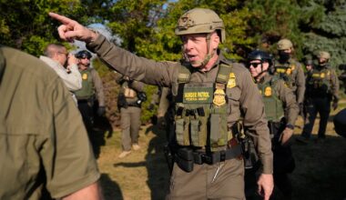 Greg Bovino, the chief patrol agent for the US Border Patrol El Centro sector, center, walks with federal immigration agents near an Immigration and Customs Enforcement facility in Broadview, Ill., on Oct. 3.