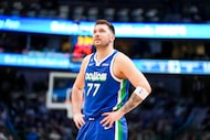 Dallas Mavericks guard Luka Doncic looks up at the scoreboard during the first half of an...