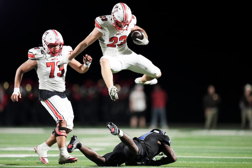 Rockwall-Heath running back Carter Zahm (23) hurdles North Forney defensive back Josiah...
