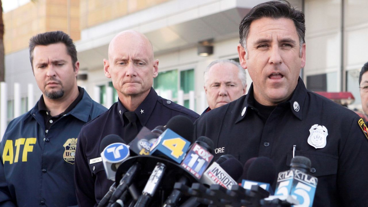 Los Angeles Fire Department Capt. Jaime Moore, right, addresses the media, Monday, Jan. 2, 2012, in Los Angeles. (AP Photo/Nick Ut)