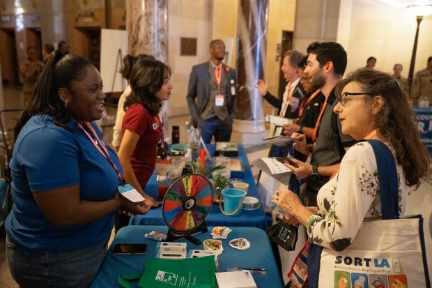Attendees stop to chat with representatives at the Los Angeles...