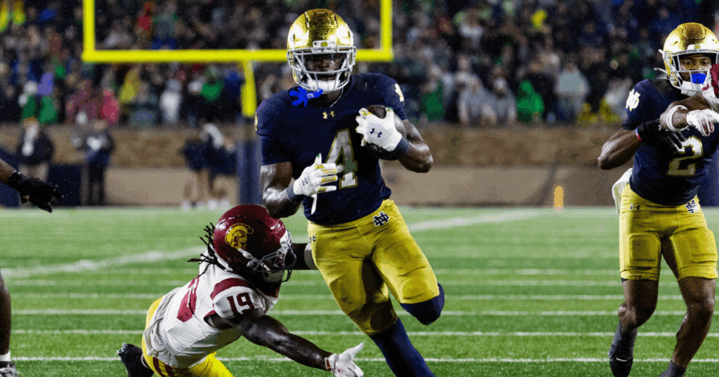 Notre Dame Fighting Irish running back Jeremiyah Love (4) runs the ball while USC Trojans safety Bishop Fitzgerald (19) defends in the second half at Notre Dame Stadium