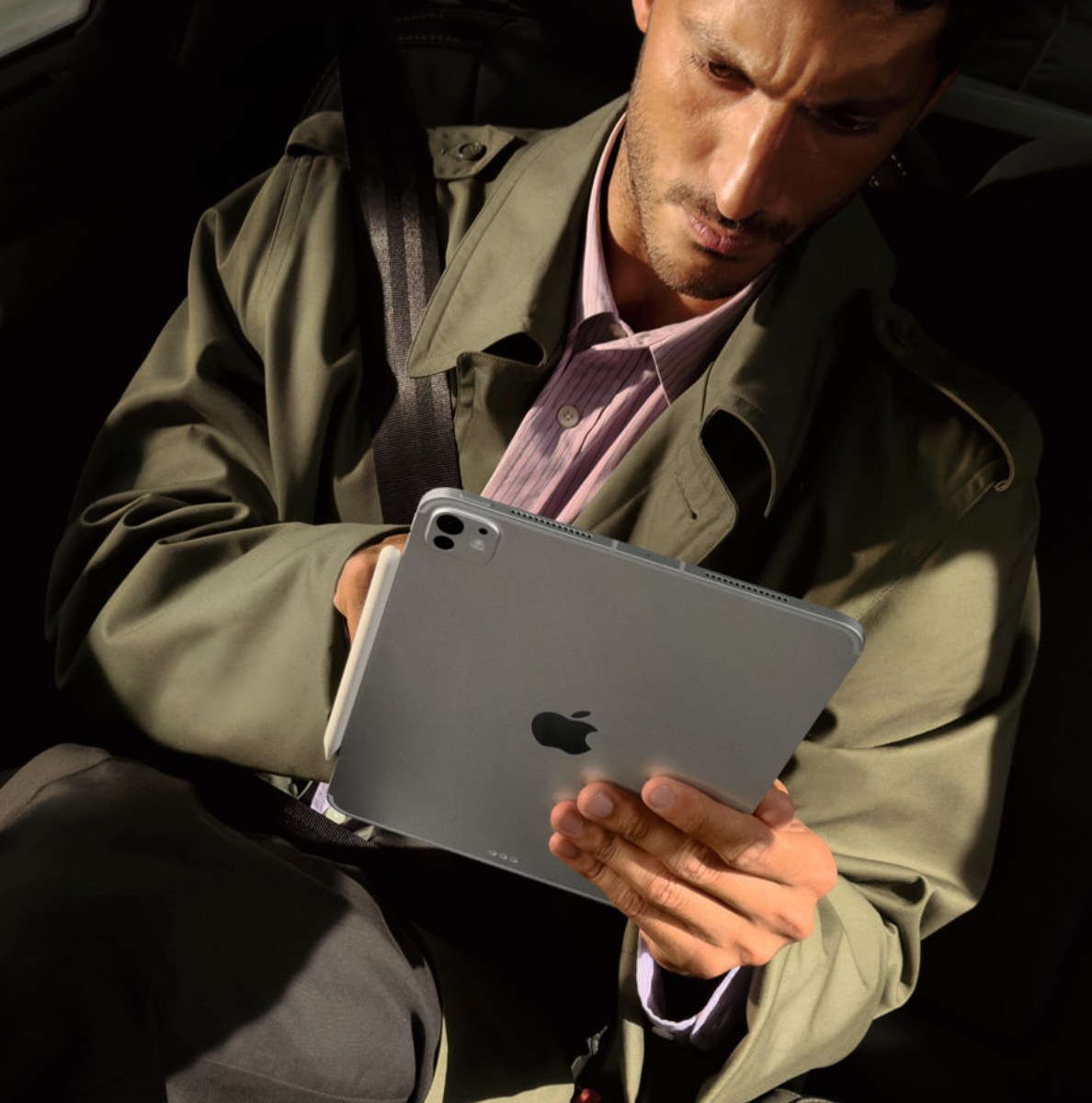 Apple's M5 iPad Pro being used by a man in a car.