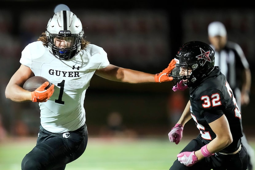 Denton Guyer running back Kaedyn Cobbs (1) pushes past Coppell safety Anthony Lewis (32)...