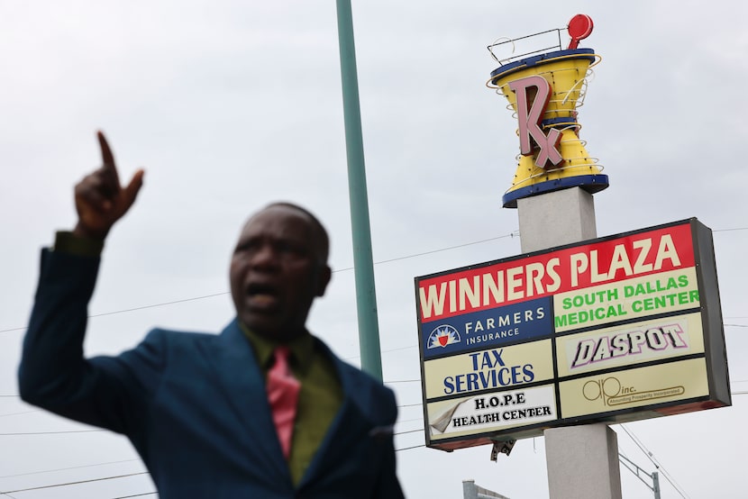 The sign of Winners Plaza is seen past Dallas Pastor Raphael Adebayo as he gives a tour of...