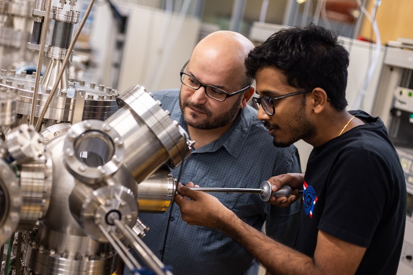 Rafik Addou (left), assistant professor of materials science and engineering, and graduate...