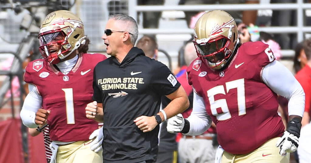 Florida State coach Mike Norvell is shown during pregame Saturday with QB Tommy Castellanos (1) and offensive guard Richie Leonard (67). (Bob Myers/Special to Warchant)