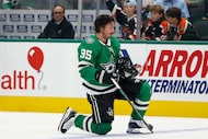Dallas Stars center Matt Duchene (95) picks up his helmet after losing it in a collision...