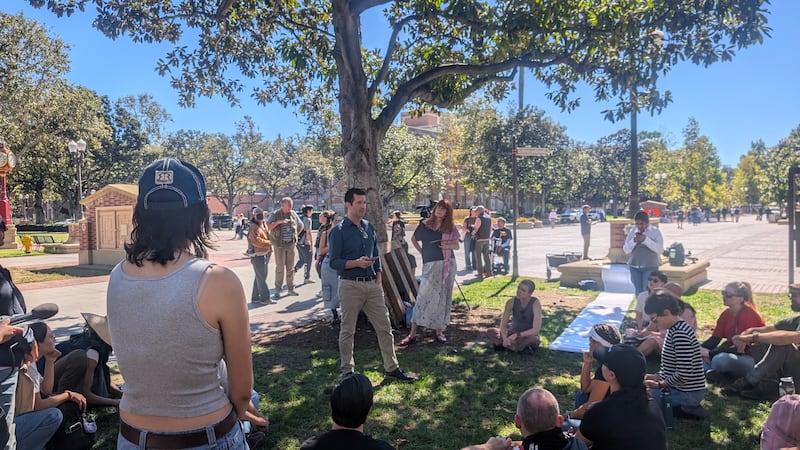 Faculty hold a teach-in near the Tommy Trojan statue on Oct. 17, 2025.